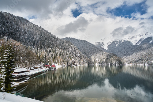Beautiful mountain Lake Ritsa. Lake Ritsa in the Caucasus Mountains, in the north-western part of Abkhazia, Georgia, surrounded by mixed mountain forests and subalpine meadows. Snow in mountains