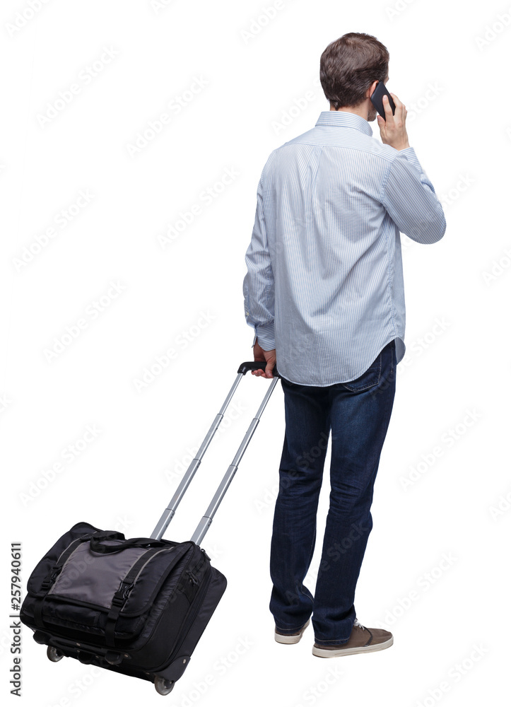 Back view of business man with suitcase talking on the phone. Back view of business man with suitcase talking on the phone.