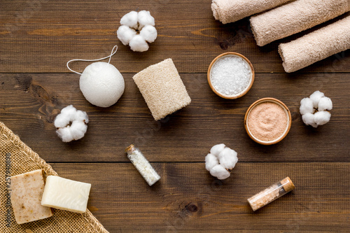 Zero waste set with cosmetics for spa and cotton materials on wooden background top view