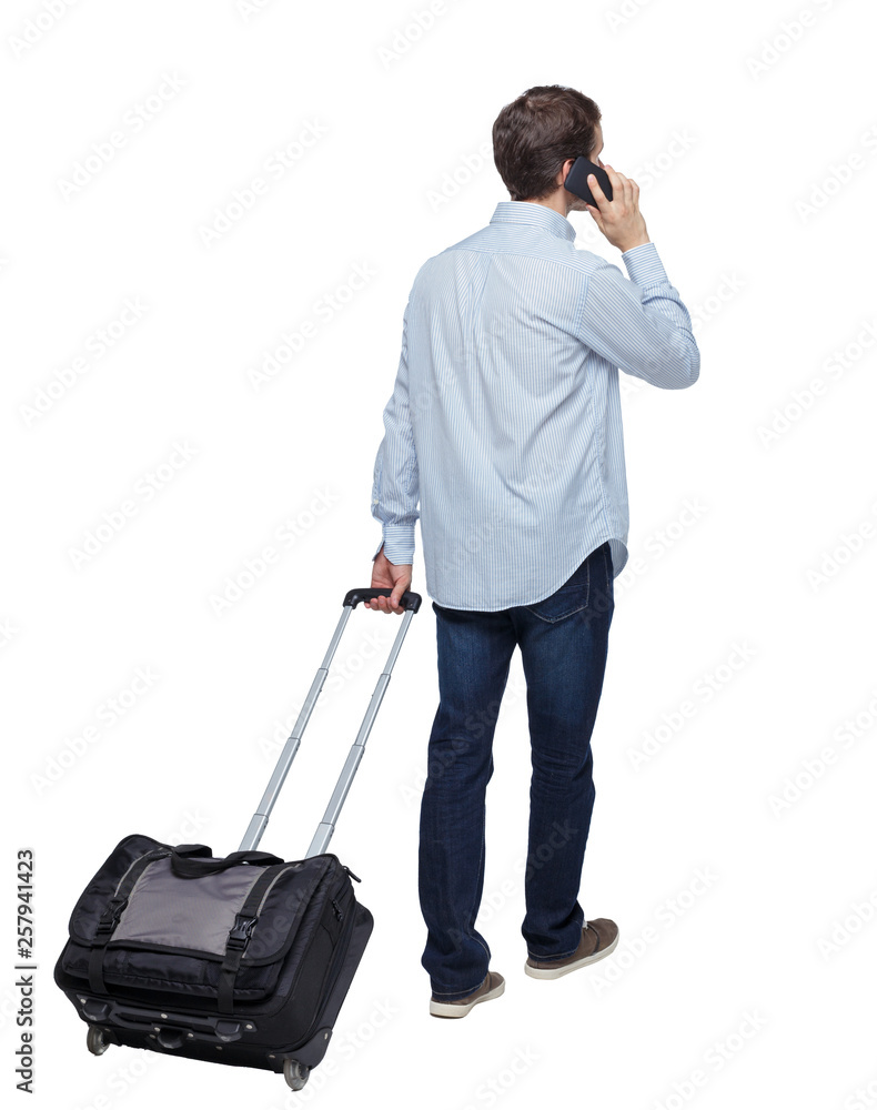 Back view of walking business man with suitcase talking on the phone. Back view of walking business man with suitcase talking on the phone.
