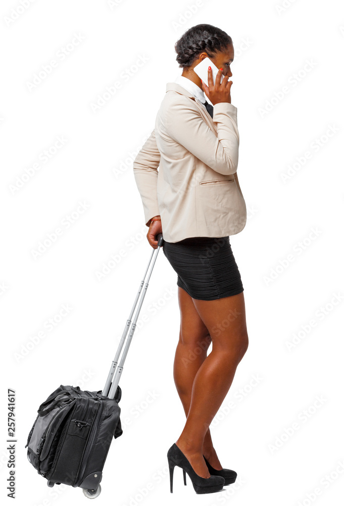 Side view of a black African-American in formal attire with a suitcase with smartphone. Side view of a black African-American in formal attire with a suitcase with smartphone.