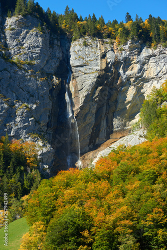 Autumn view with the waterfall on the rocks in Lauterbrunnen valley in Switzerland.