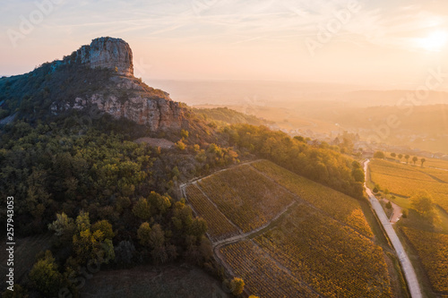 Aerial view of vineyard with Rock of Solutre during sunrise photo