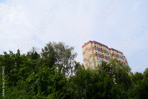 Bottom view of a multi-storey building against the sky. © YAROSLOVEPHOTOVIDEO