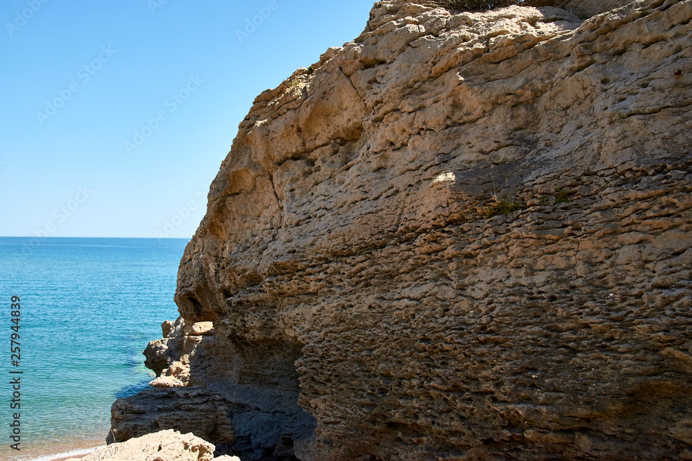 Layered rock on the beach of Platja de Pals in a beautiful summer day, Costa Brava, Catalonia, Spain
