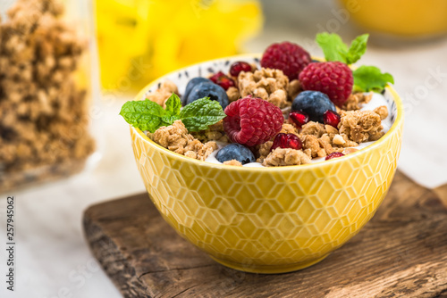 Breakfast or brunch  granola with milk and berry fruits