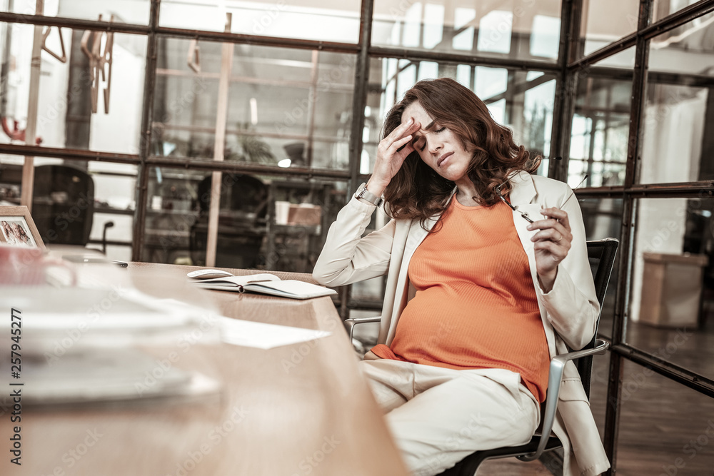 Fototapeta premium Disturbed long-haired woman being in hard emotional and physical condition