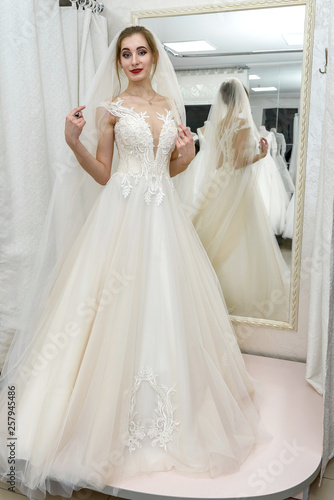 Young bride in salon looking in mirror at her reflection