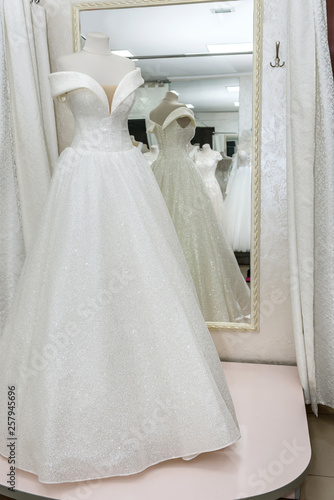 Beautiful wedding dress on a mannequin in salon