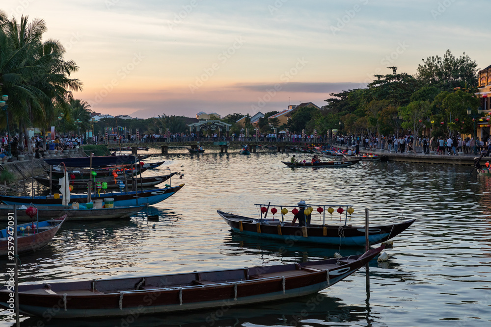 Traditional boats in front of ancient architecture in Hoi An, Vietnam. Hoi An is the World's Cultural heritage site, famous for mixed cultures & architecture.