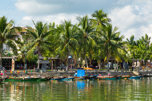 Traditional boats in front of ancient architecture in Hoi An, Vietnam. Hoi An is the World's Cultural heritage site, famous for mixed cultures & architecture. © Curioso.Photography