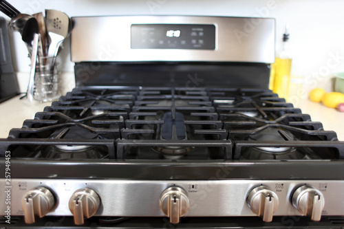 Modern stainless steel gas stove oven in a home kitchen.