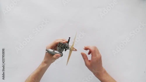 hands of a young man disassemble micromotor for model aircraft photo