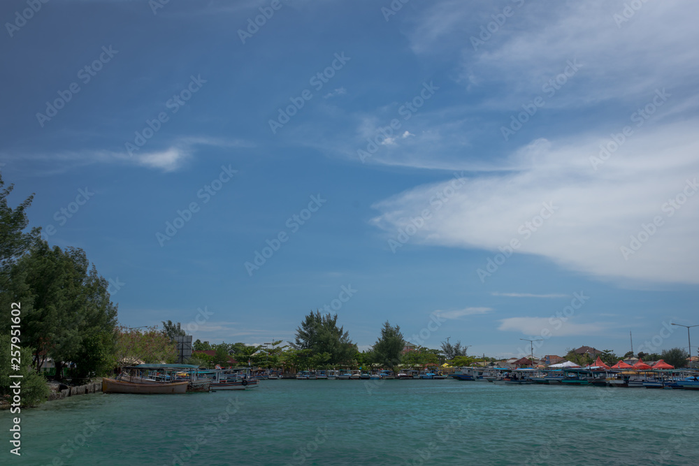 The traditional port on Harapan Island, Indonesia with fishing boats that are waiting and ready to bring tourists to explore the beauty of the island