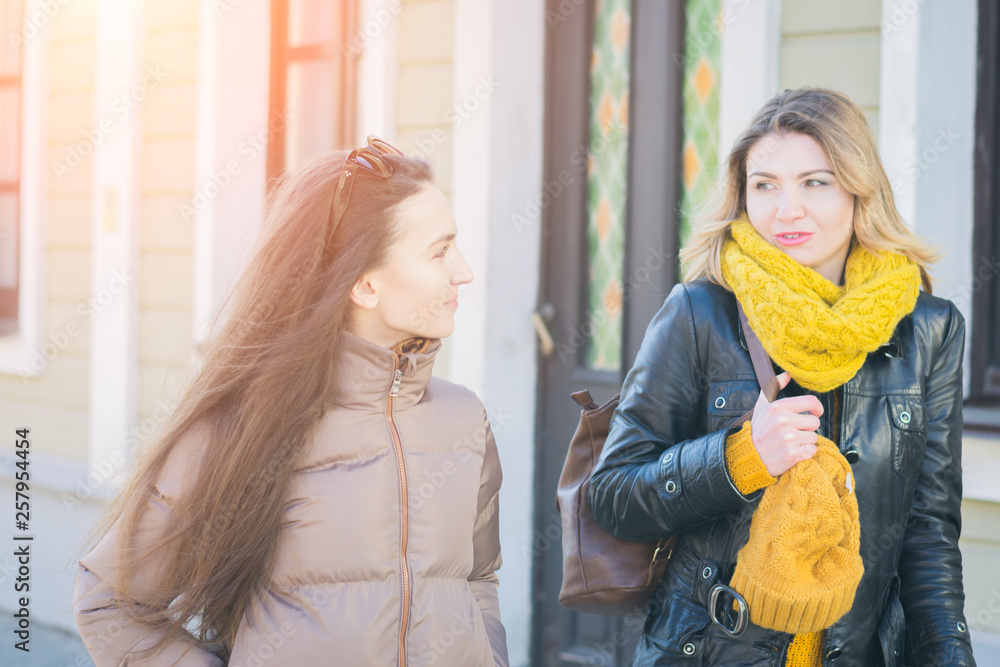 Fototapeta premium Two beautiful women walking in the street