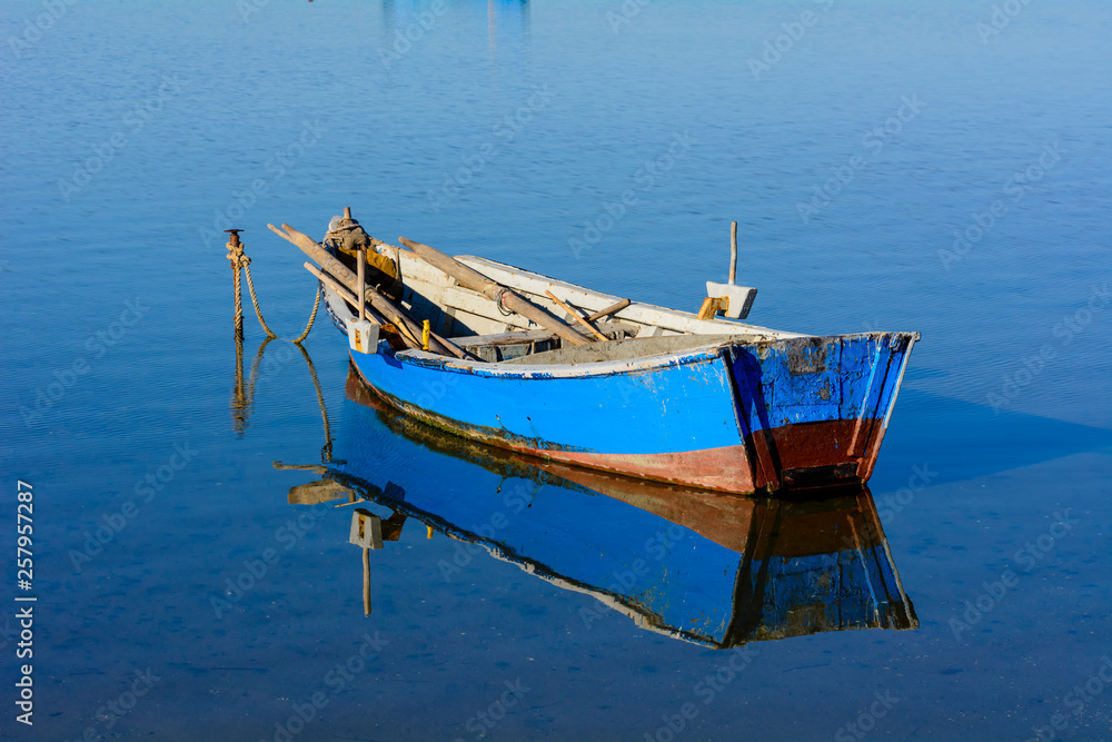 Fototapeta premium Old fishing boats with bright colors at dawn on the lake.