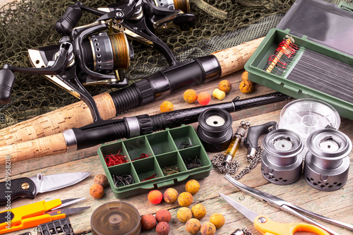 fishing tackle on a wooden table. toned image 