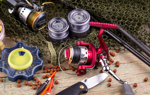 fishing tackle on a wooden table. toned image 