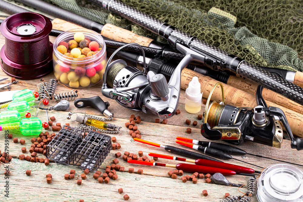 fishing tackle on a wooden table. toned image fishing tackle on a wooden table. toned image