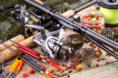 fishing tackle on a wooden table. toned image 