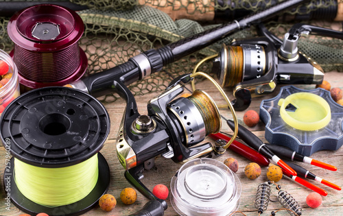 fishing tackle on a wooden table. toned image 