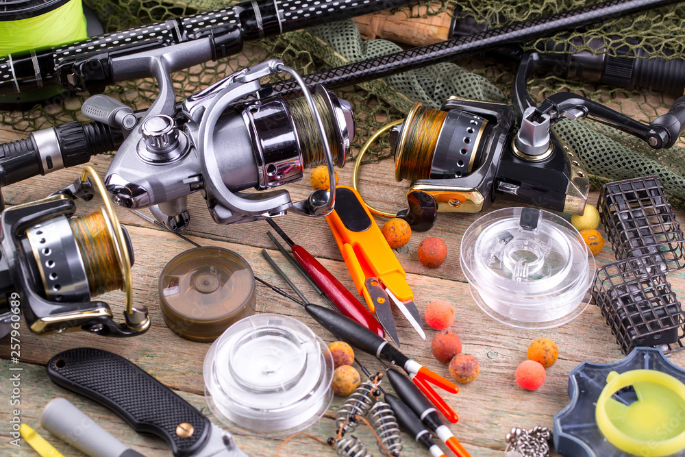 fishing tackle on a wooden table. toned image fishing tackle on a wooden table. toned image