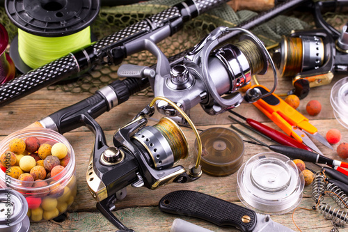 fishing tackle on a wooden table. toned image 