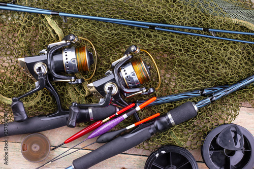 fishing tackle on a wooden table. toned image 