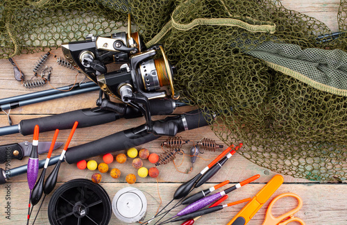 fishing tackle on a wooden table. toned image 