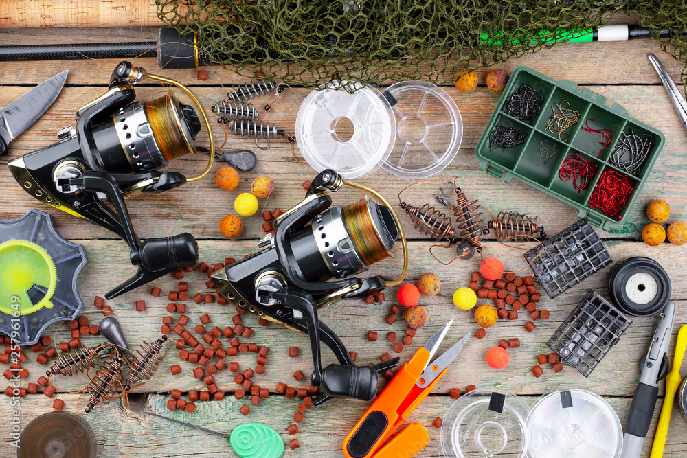 fishing tackle on a wooden table. toned image fishing tackle on a wooden table. toned image
