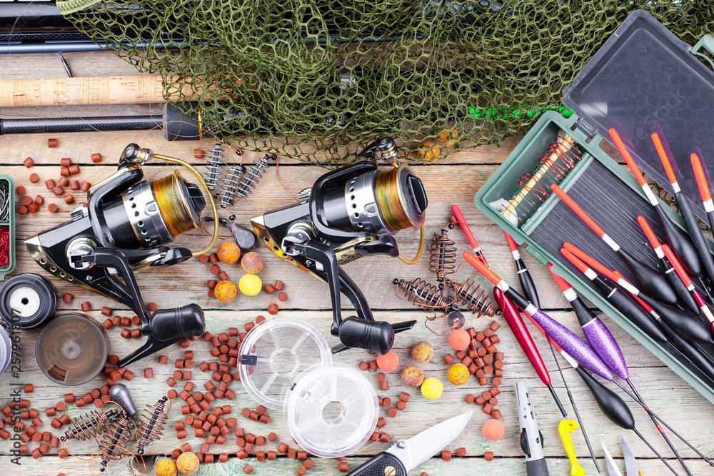 fishing tackle on a wooden table. toned image fishing tackle on a wooden table. toned image