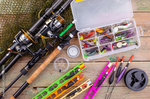 fishing tackle on a wooden table. toned image 