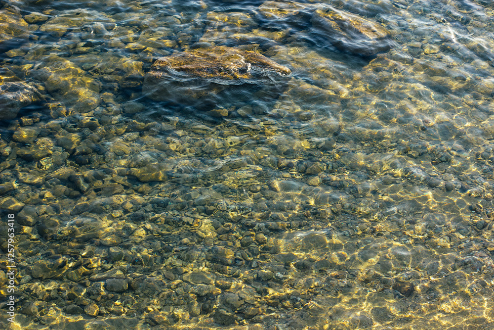 aerial local landscape photography shallow water rocky shoreline of north river mountain stream with blurred from the sun surface, copy space