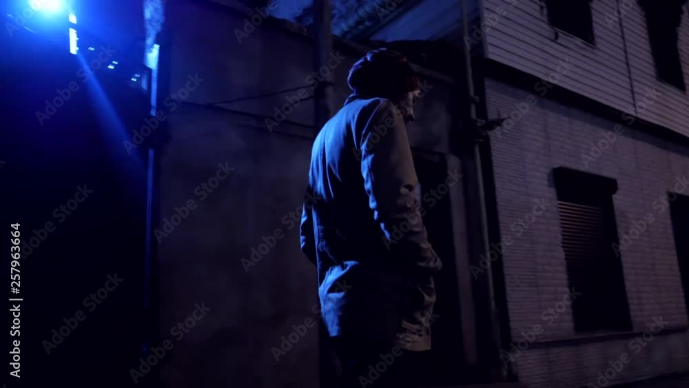 Depression bearded man walks at empty dark street in night city Depression bearded man walks at empty dark street in night city
