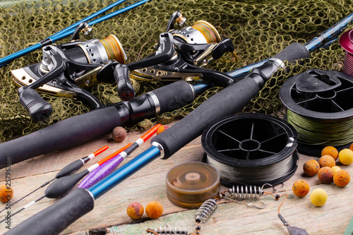 fishing tackle on a wooden table. toned image 