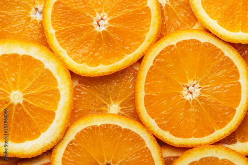 Slices of fresh juicy orange as background.
