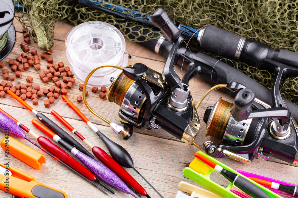 fishing tackle on a wooden table. toned image 