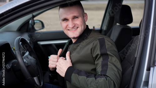 Attractive smiling happy young man in a car © brillianata