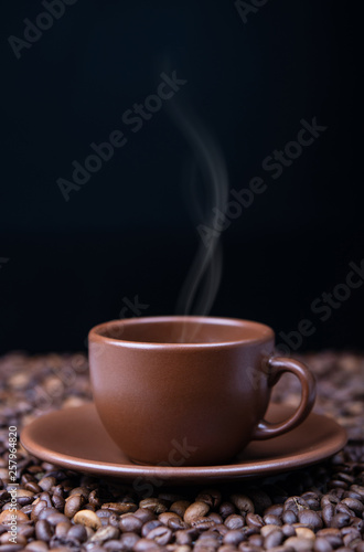 Steaming coffee cup on black background,