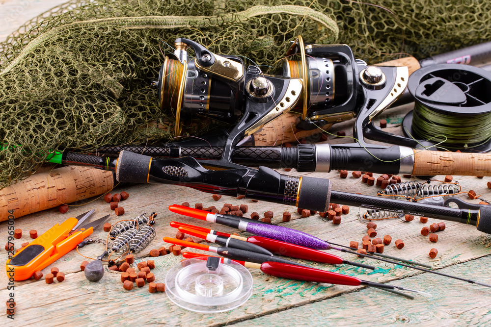 fishing tackle on a wooden table. toned image fishing tackle on a wooden table. toned image
