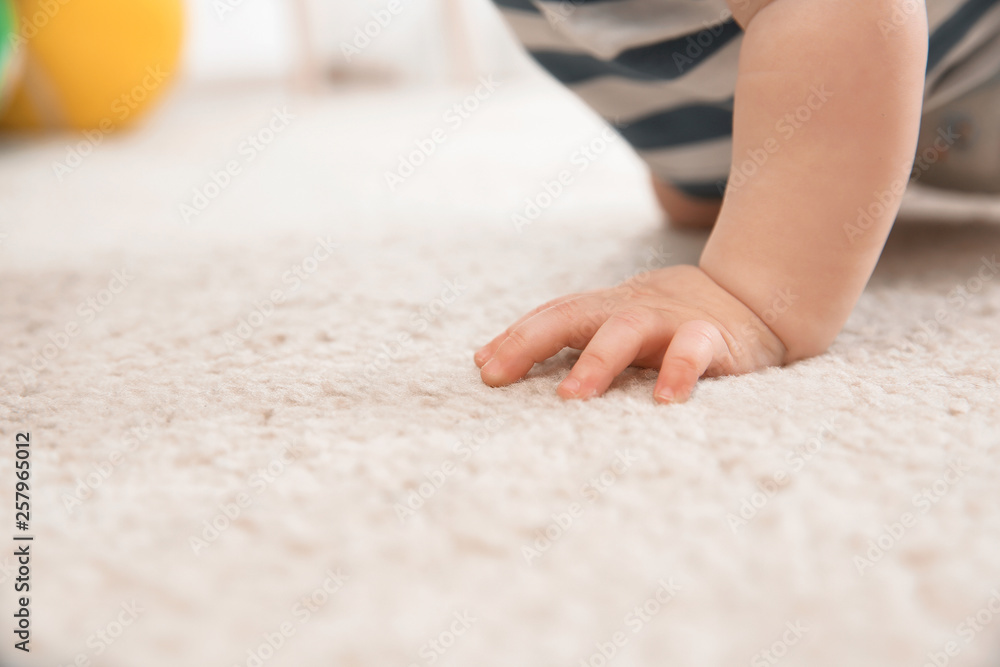 Cute little baby crawling on carpet indoors, closeup with space for text Cute little baby crawling on carpet indoors, closeup with space for text