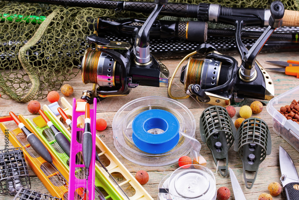 fishing tackle on a wooden table. toned image fishing tackle on a wooden table. toned image