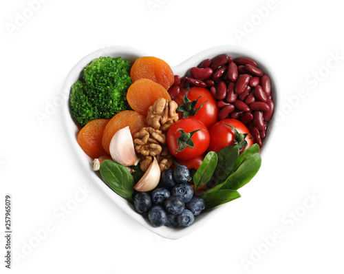 Bowl with products for heart-healthy diet on white background, top view