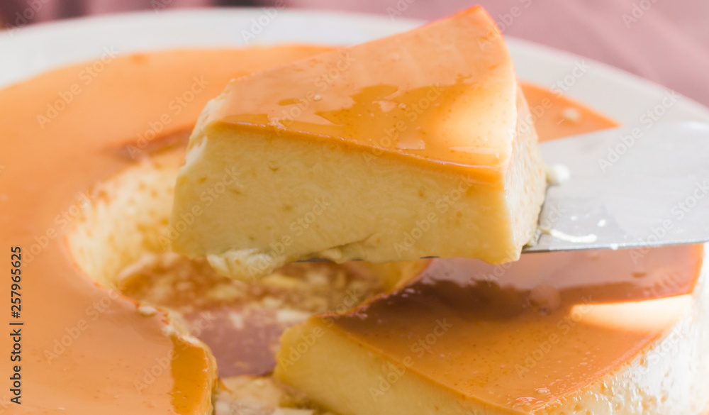 Milk Pudding or Pudim de leite. Brazilian dessert homemade caramel custard pudding and condensed milk. Traditional brazilian flan. Blurred background. Milk Pudding or Pudim de leite. Brazilian dessert homemade caramel custard pudding and condensed milk. Traditional brazilian flan. Blurred background.