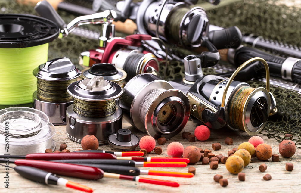 fishing tackle on a wooden table. toned image fishing tackle on a wooden table. toned image