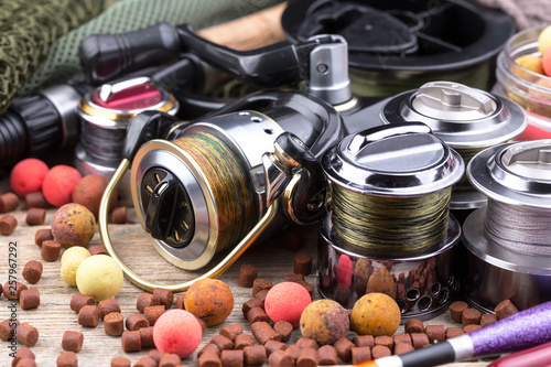 fishing tackle on a wooden table. toned image 