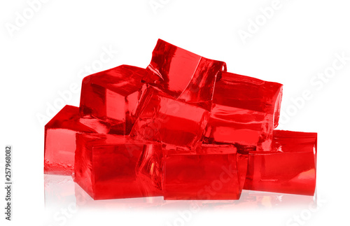 Foto Heap of red jelly cubes on white background
