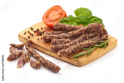 Dry wild meat sticks. Jerky sausages close-up, isolated on white background