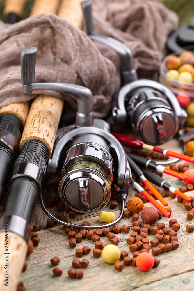 Obraz premium fishing tackle on a wooden table. toned image 
