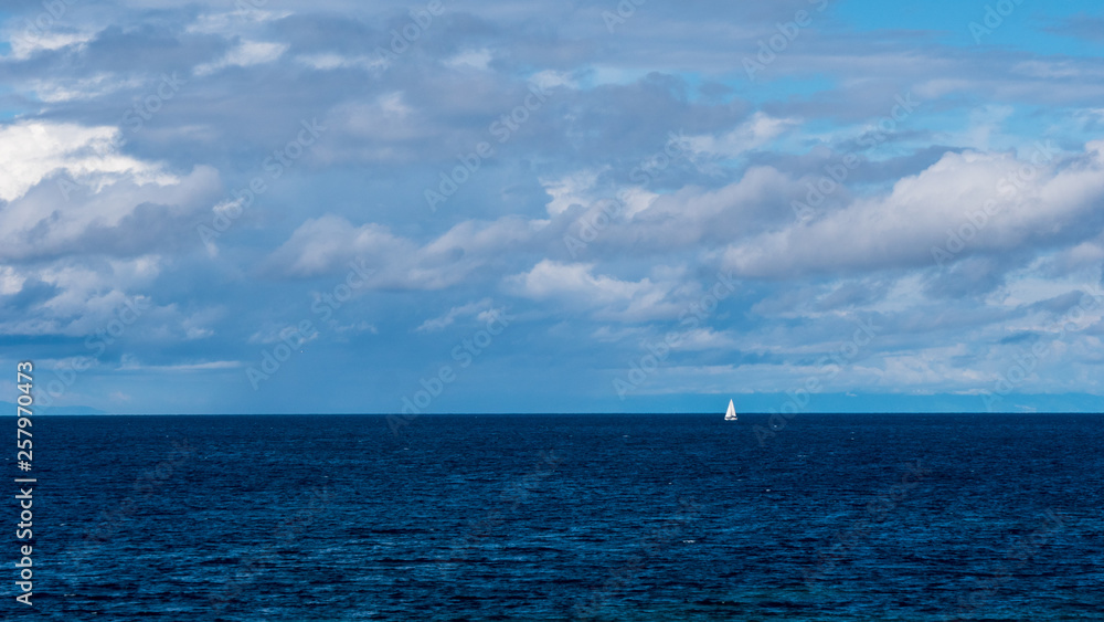 Sailing boat in the sea and blue sky Sailing boat in the sea and blue sky
